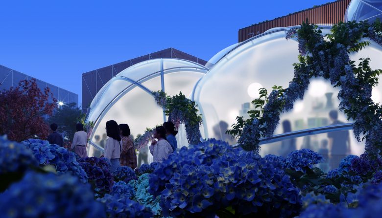 Вечерний вид павильона с подсветкой и посетителями The Swiss Pavilion at Expo Osaka 2025